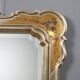 Antique mirror with a gilded frame and floral decorations, Italy, 20th century.