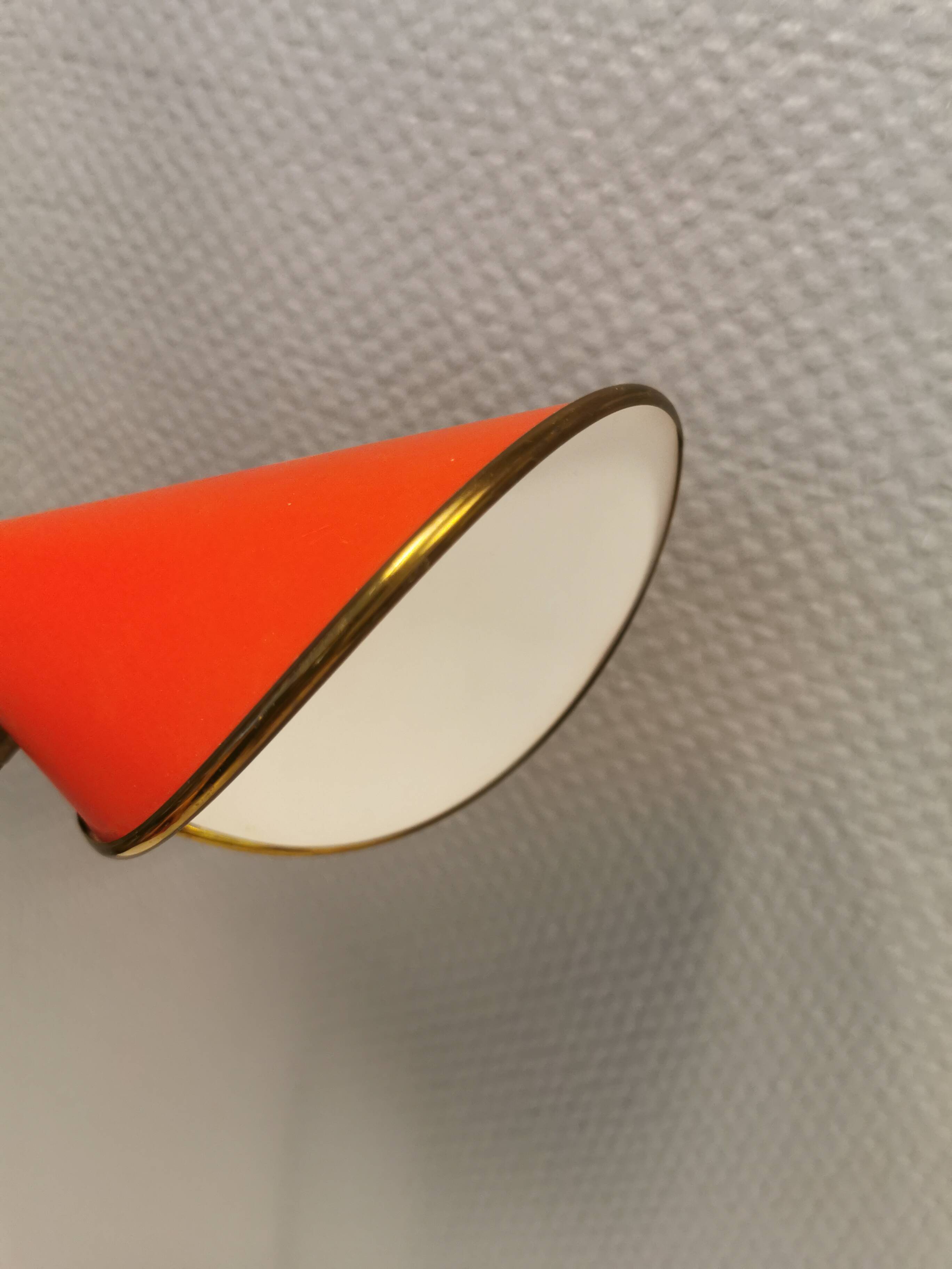 Danish red lacquered wall light with brass details. Estimated 1980s