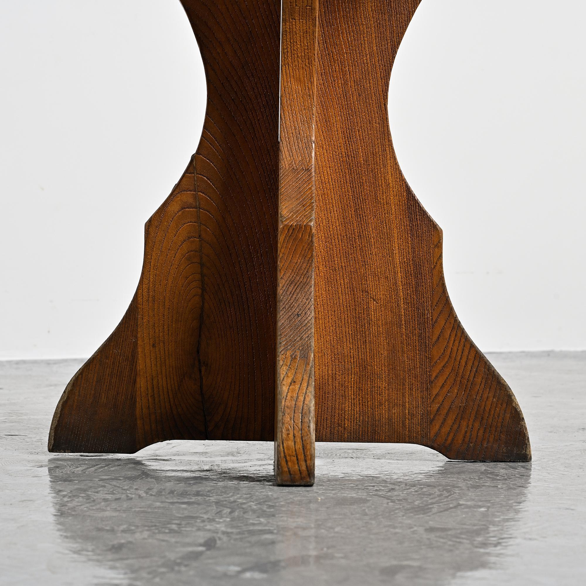Solid pine table, sculpted cross legs, French Alps, around 1970.