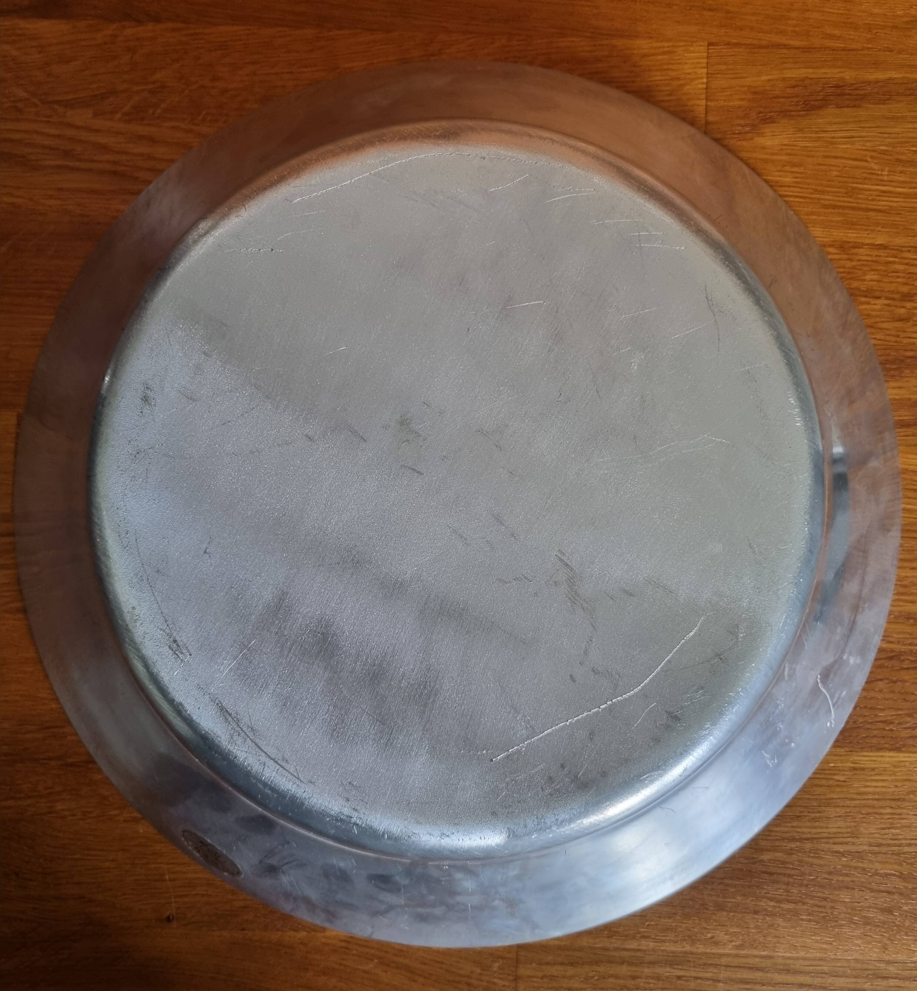 Large round hollow metal dish