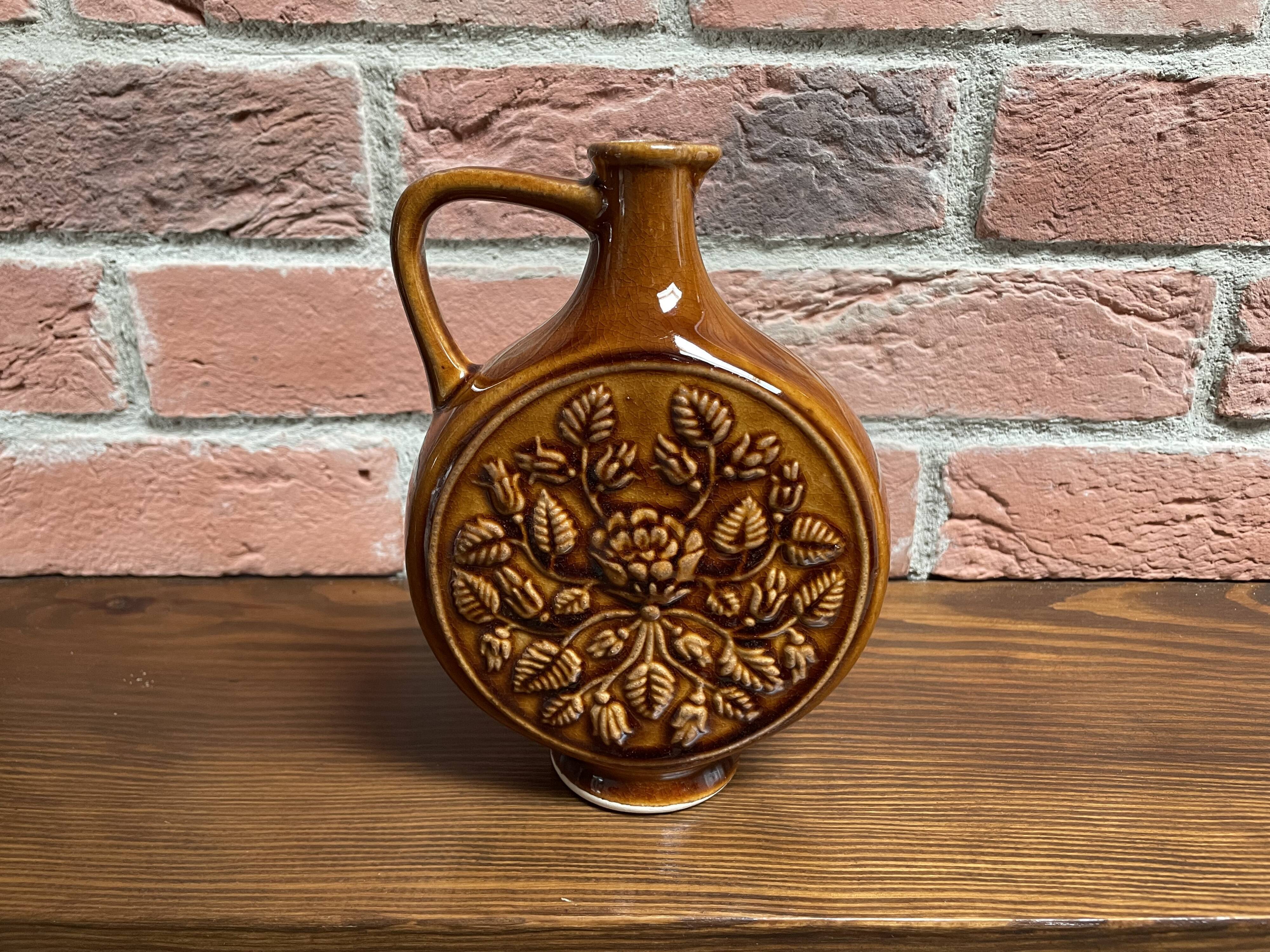 German round vase with floral motif, ornamental brown ceramic jug with handle