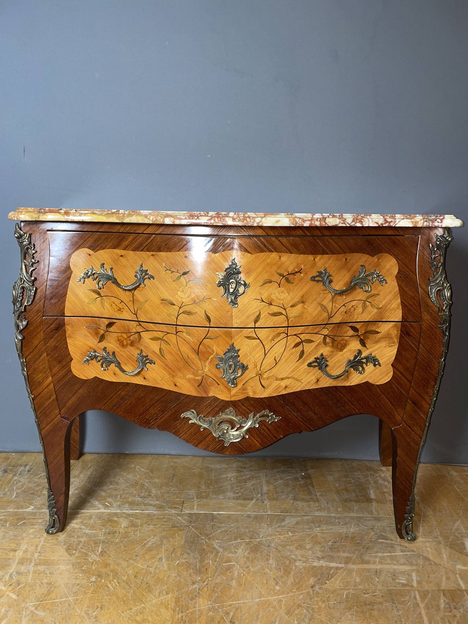 Louis XV style commode with floral marquetry decoration.