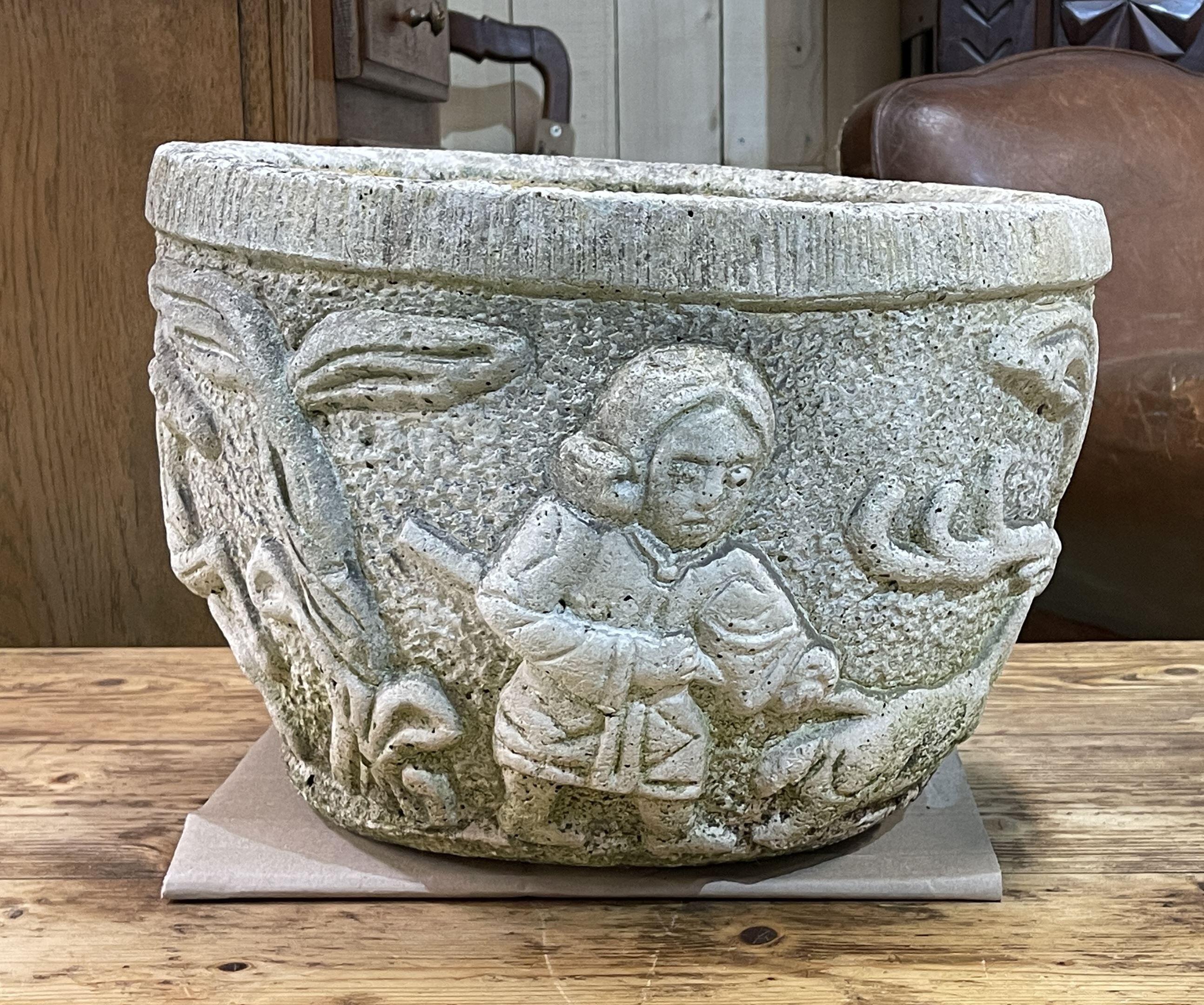 Reconstituted stone planter with hunting decoration