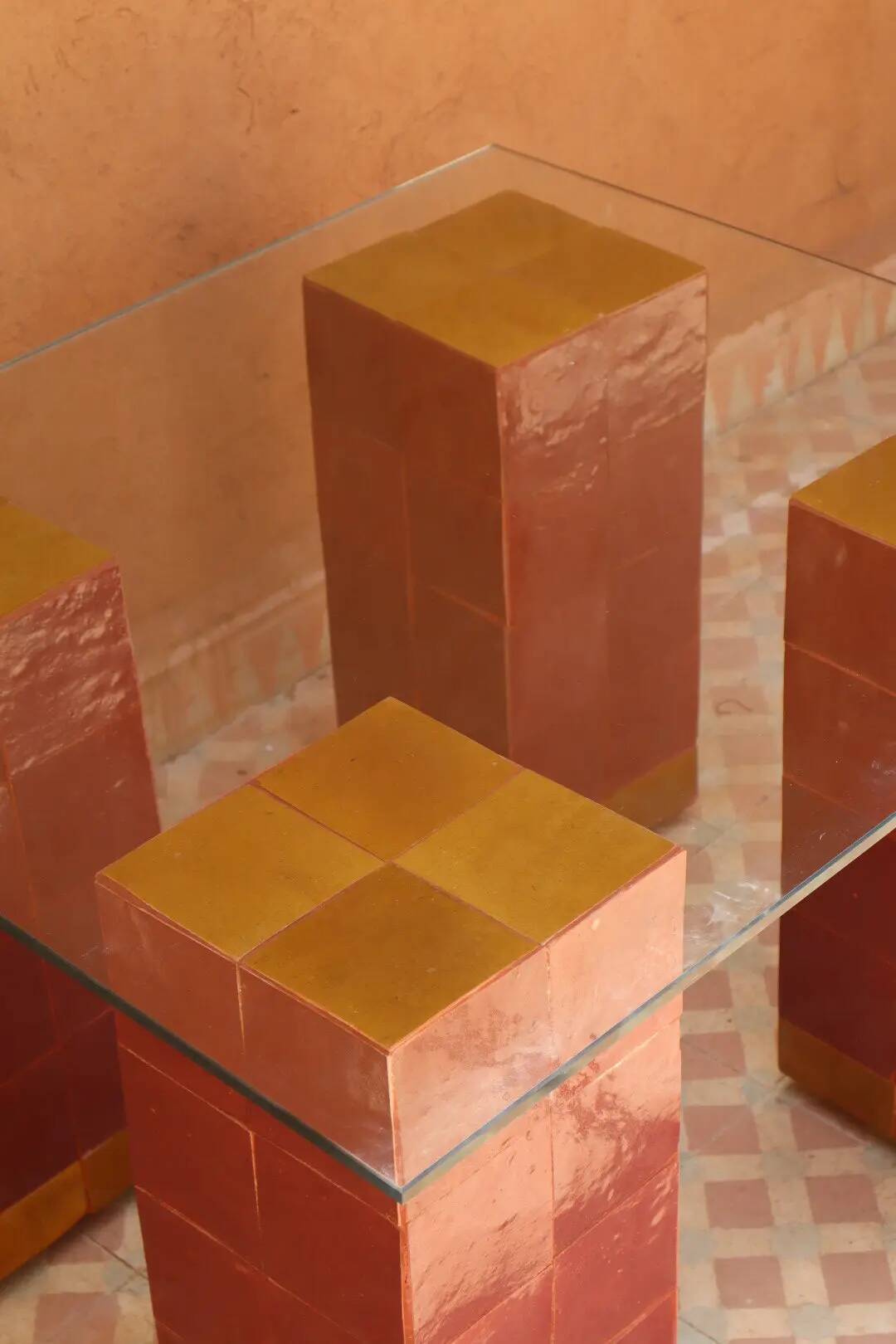 Modern coffee table in burgundy zellige with a tempered glass top.