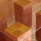 Modern coffee table in burgundy zellige with a tempered glass top.