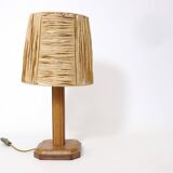 Lamp base in saddle stitched leather and raffia lampshade.