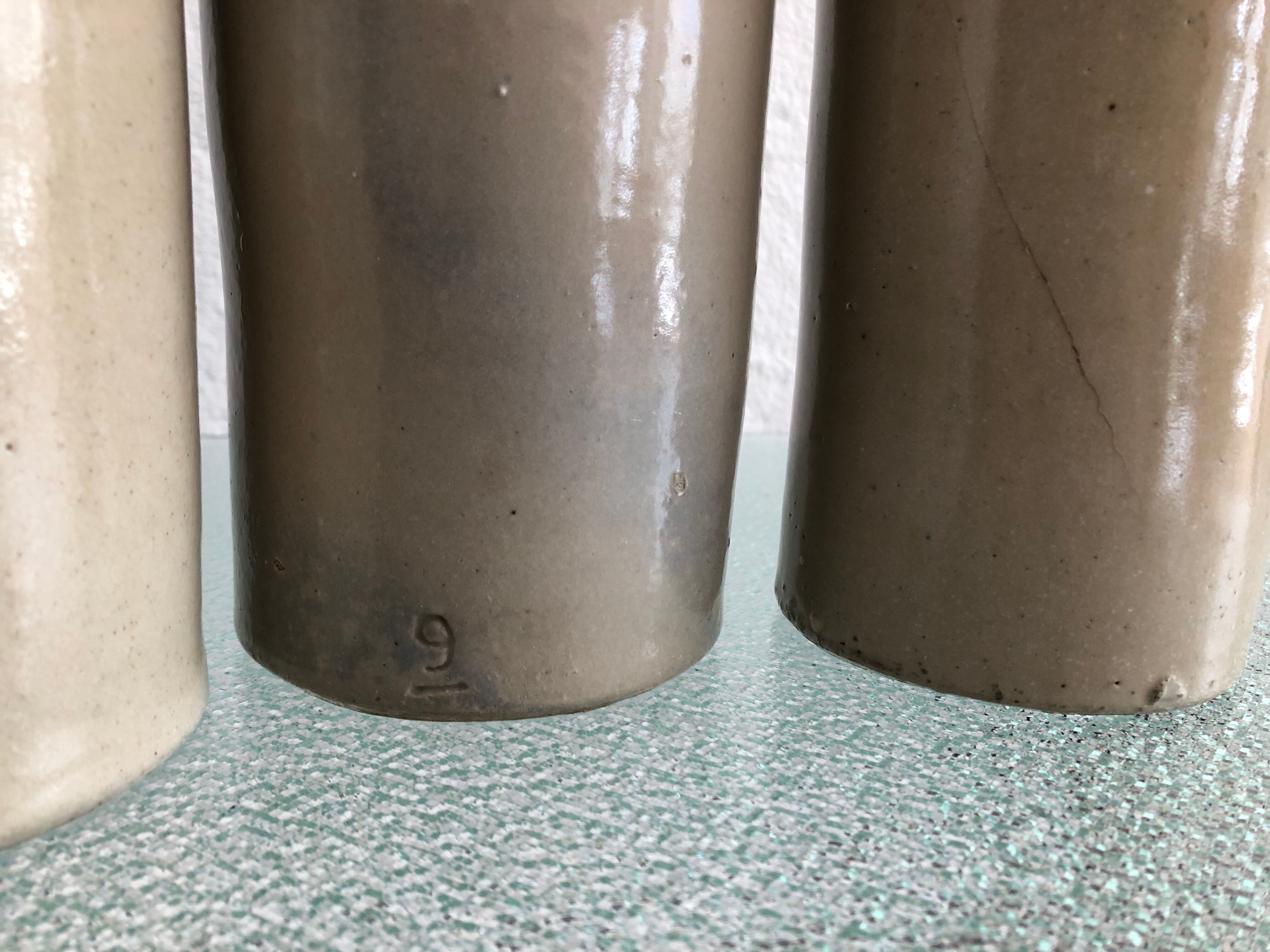 Trio of vintage stoneware bottles