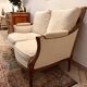 Two-seater canapé by Roche Bobois in Louis XVI style — carved wood, caned sides.