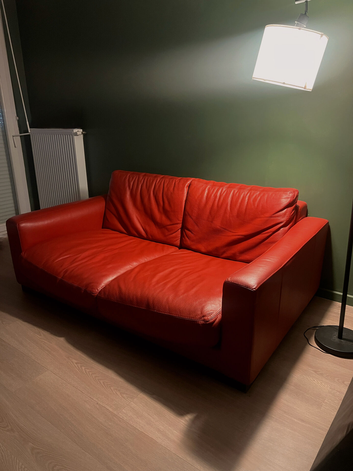 Red leather 2/3-seater sofa by Roche Bobois