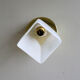 Translucent antique glass wall lamp mounted on a brass metal stand