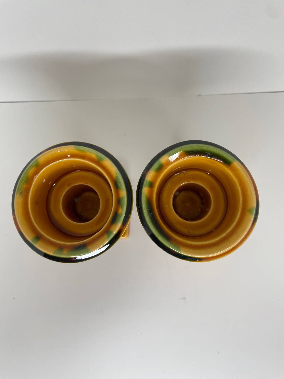 Pair of ocher and green ceramic point-a-line candlesticks