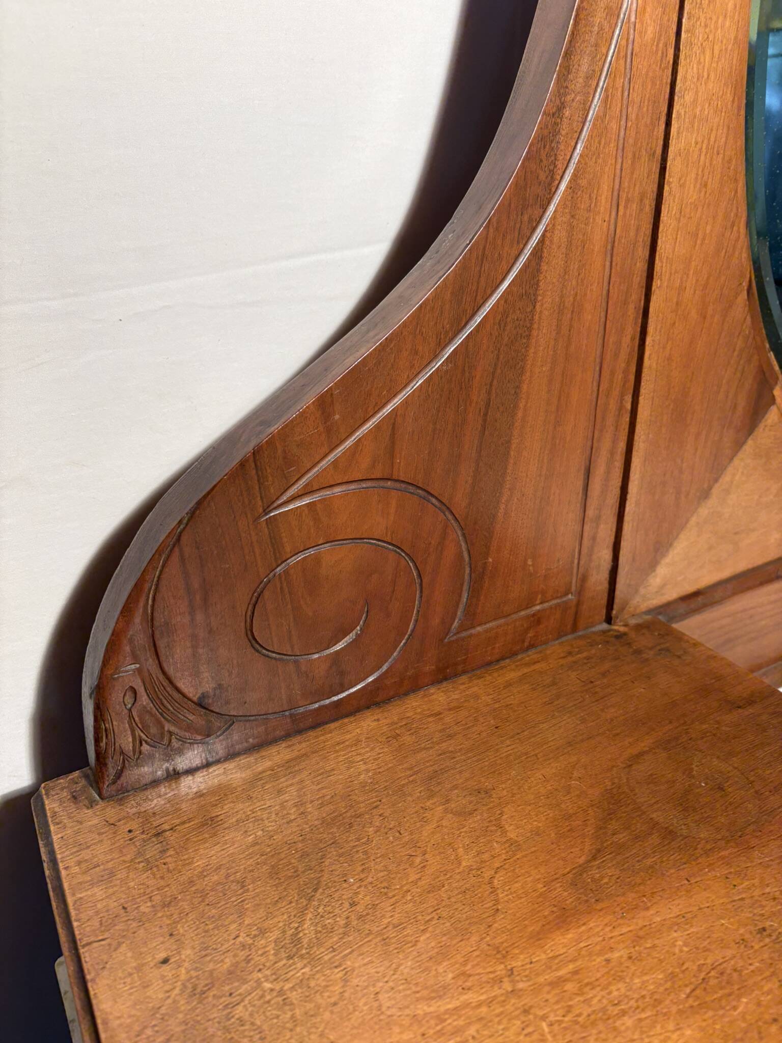 Antique carved wooden dressing table with marble and tilting oval mirror.