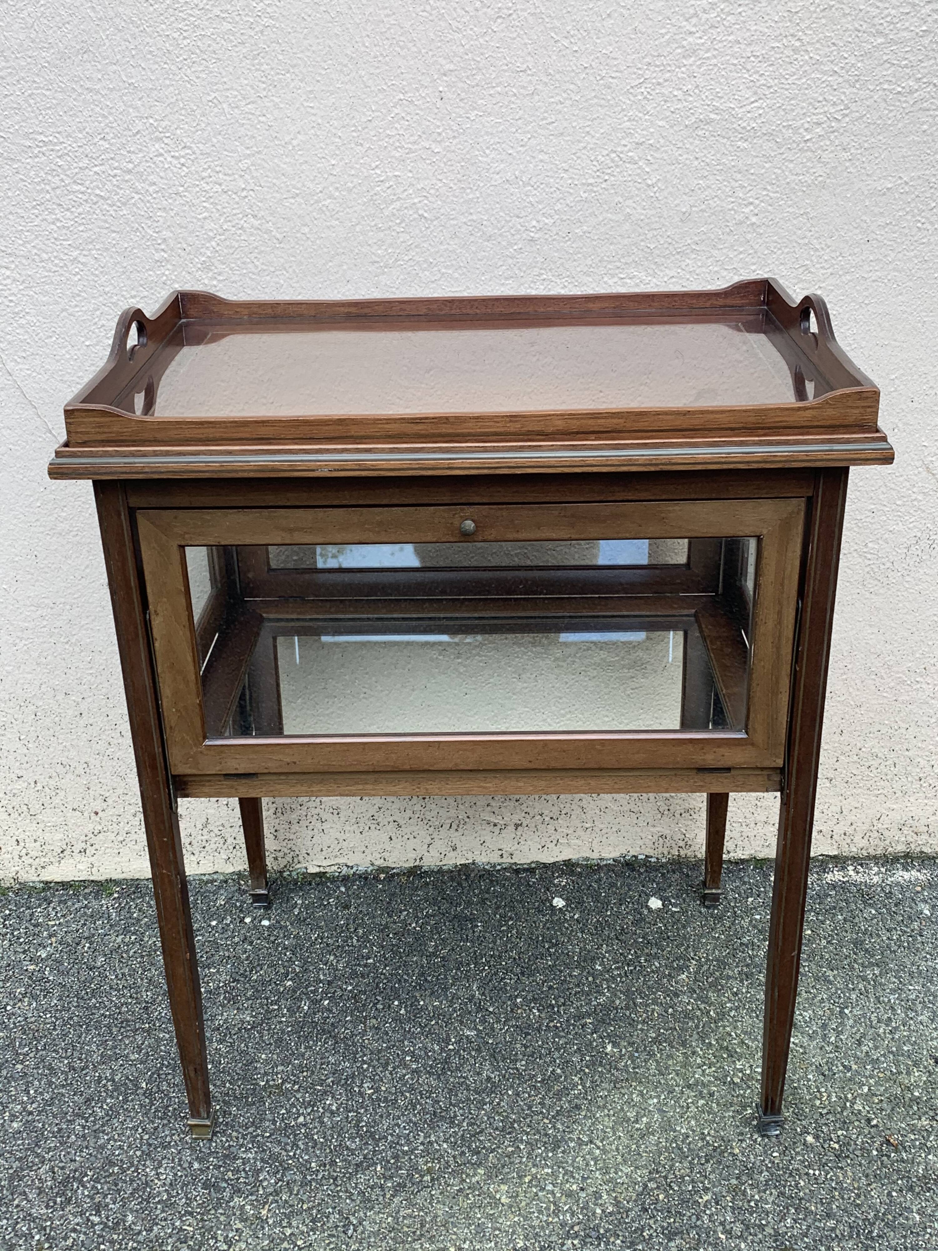 Glass-enclosed old tea table with wooden tray, bronze and brass