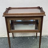 Glass-enclosed old tea table with wooden tray, bronze and brass