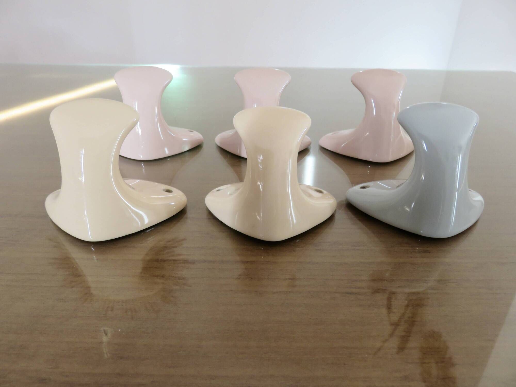 Pair of salmon-colored art deco porcelain hooks from the 30s and 40s
