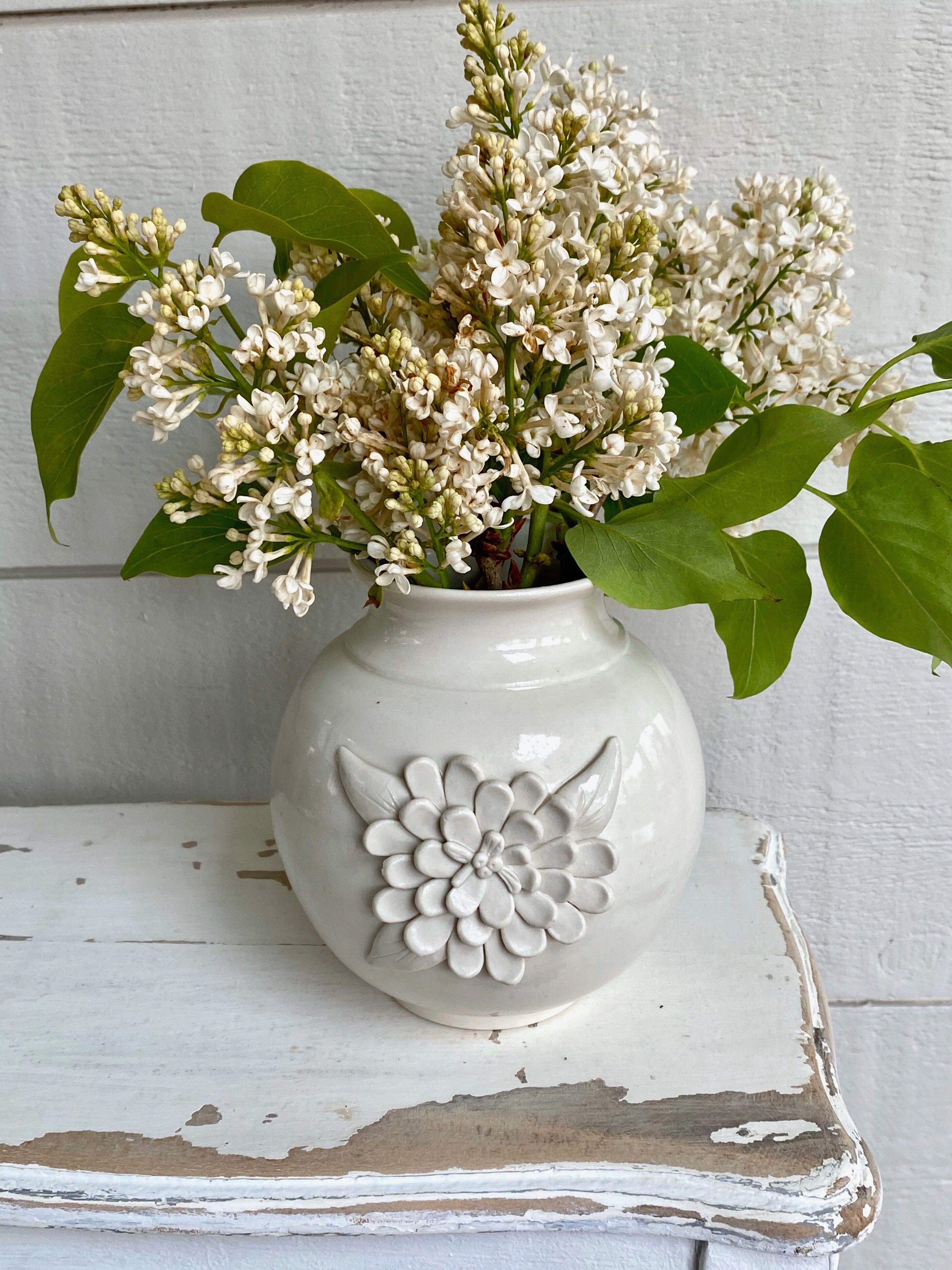 Small ceramic vase with floral relief