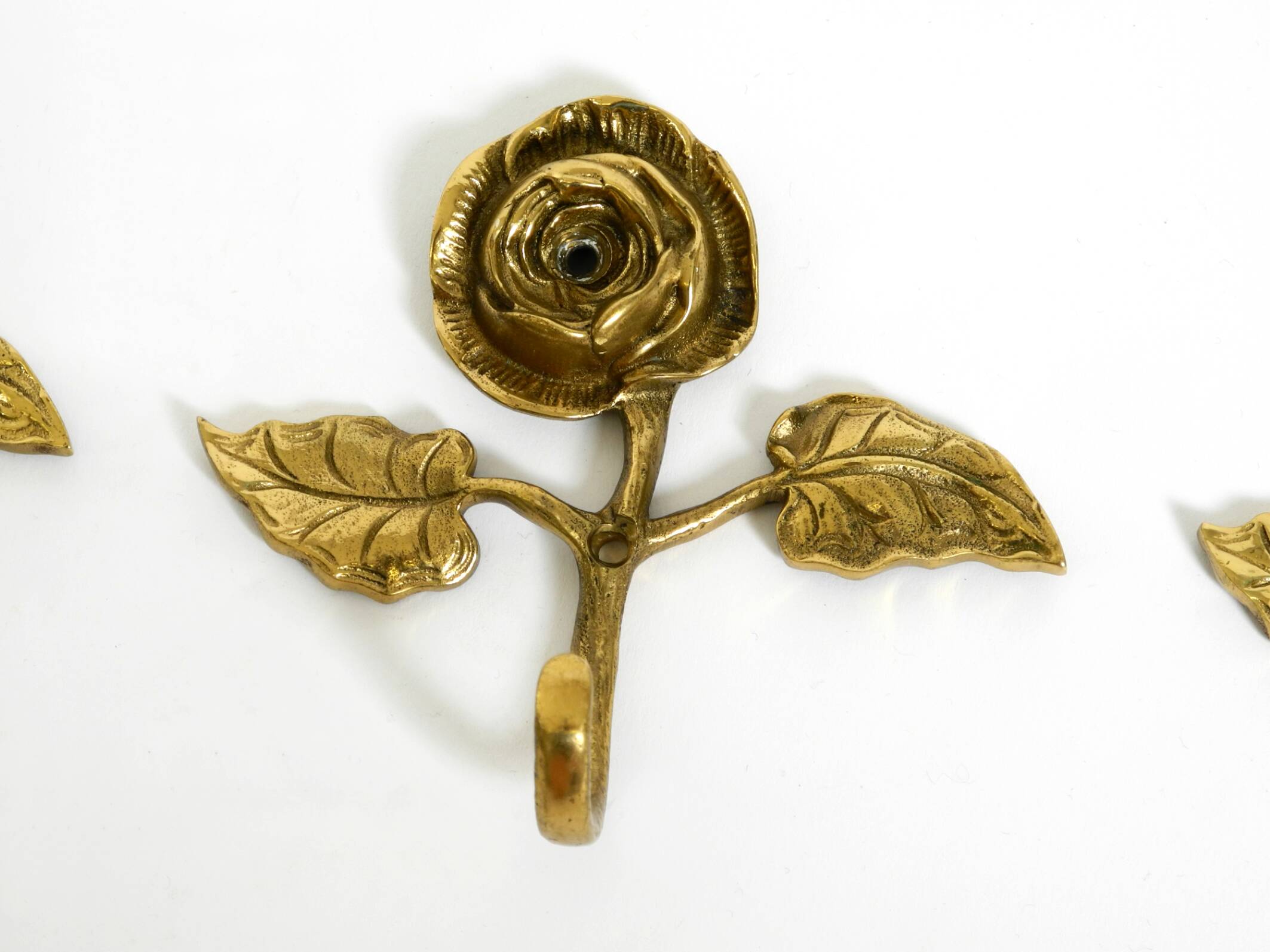 Set of five beautiful, solid mid-century brass rose wall coat hooks
