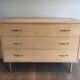 Eggshell lacquered chest of drawers with brushed steel legs. In the style of Knoll.