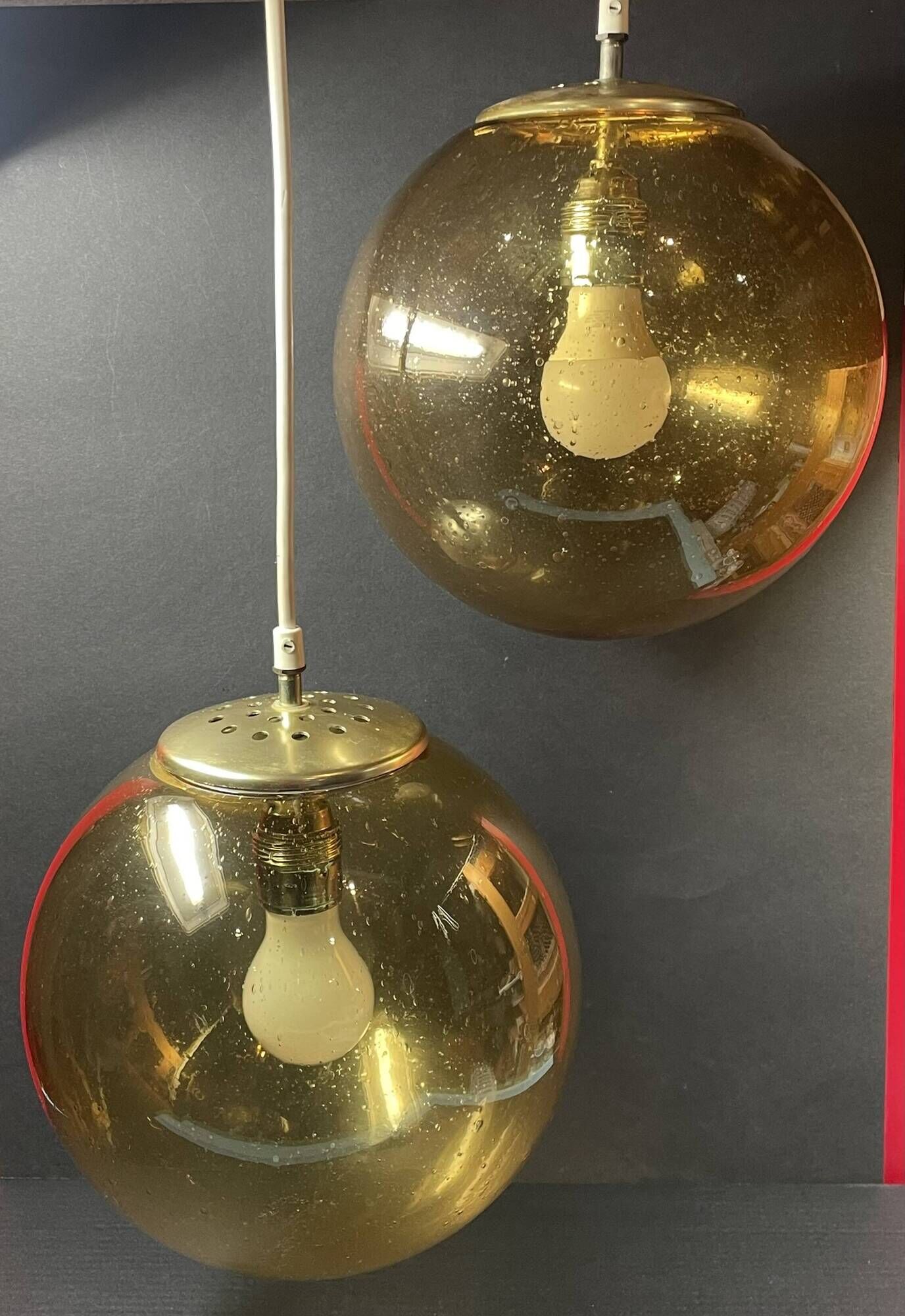 Pair of vintage smoked glass ball pendant lights from Biot glassworks
