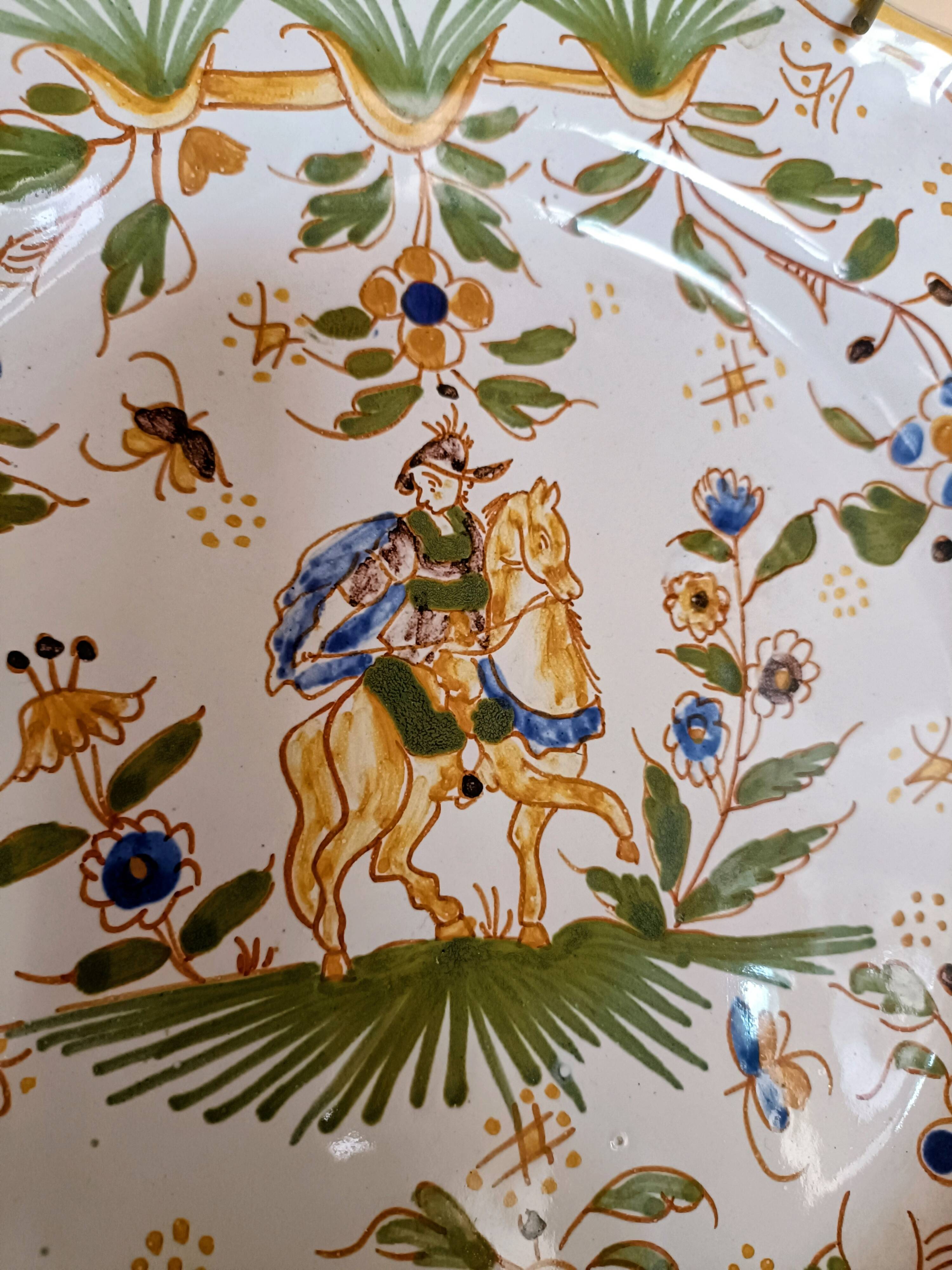 Antique Moustiers plate hand-decorated with a horseman.