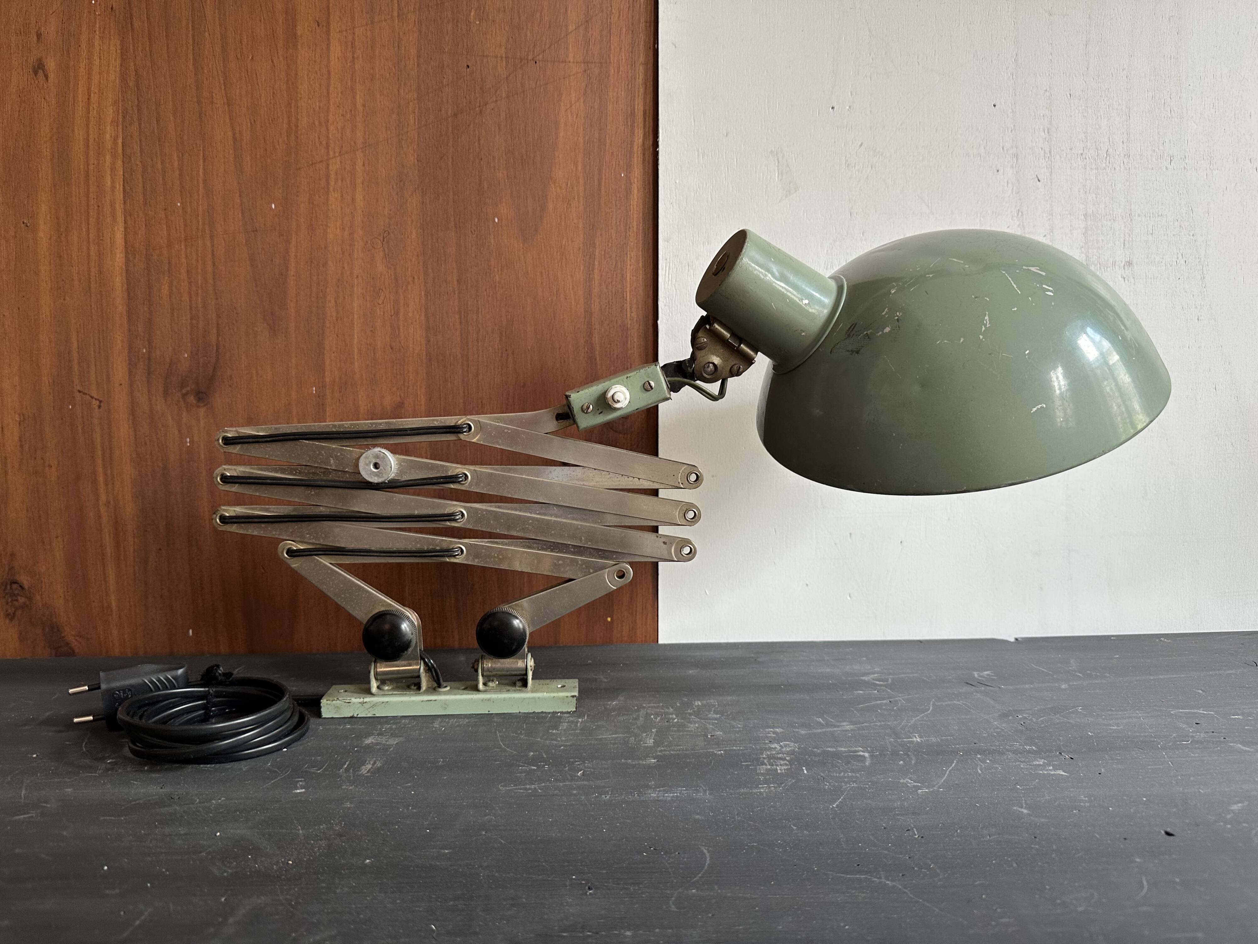 Old extendable accordion lamp in celadon green, workshop spirit.