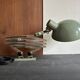 Old extendable accordion lamp in celadon green, workshop spirit.