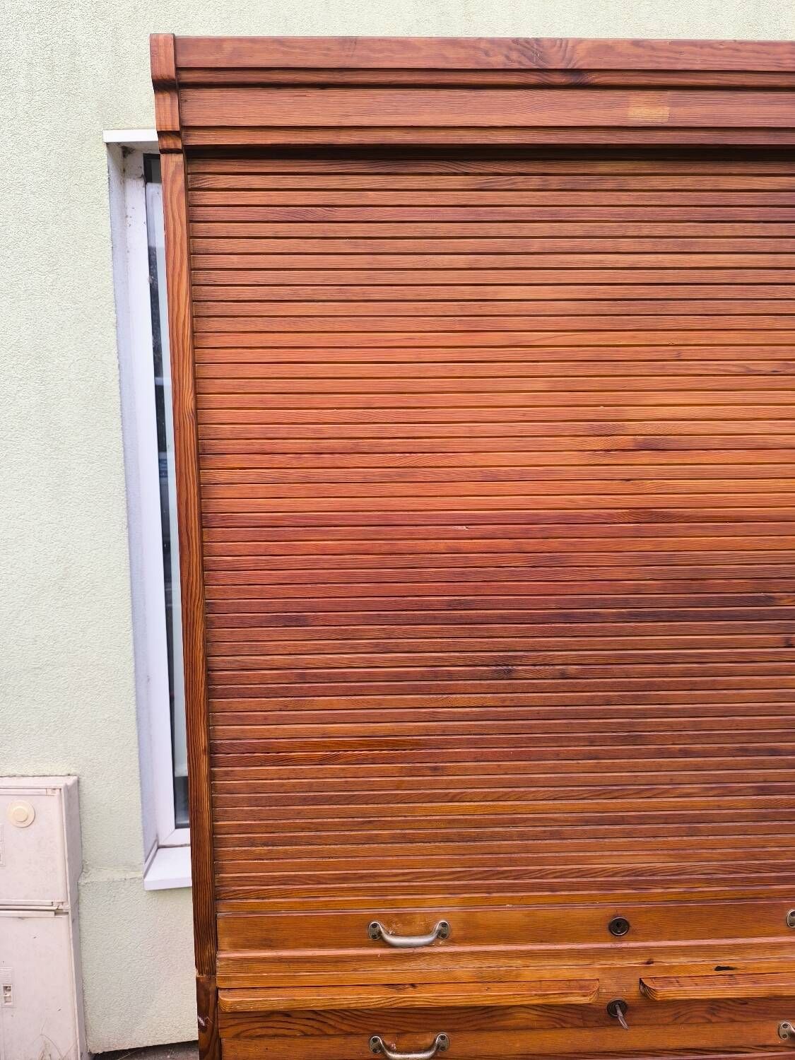 Vintage 1940s secretary desk with wooden curtains, storage, and shutters.