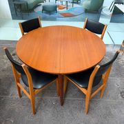 4 Scandinavian chairs in teak and black faux leather.