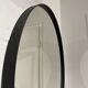 Round mirror 75cm in diameter with a black frame.