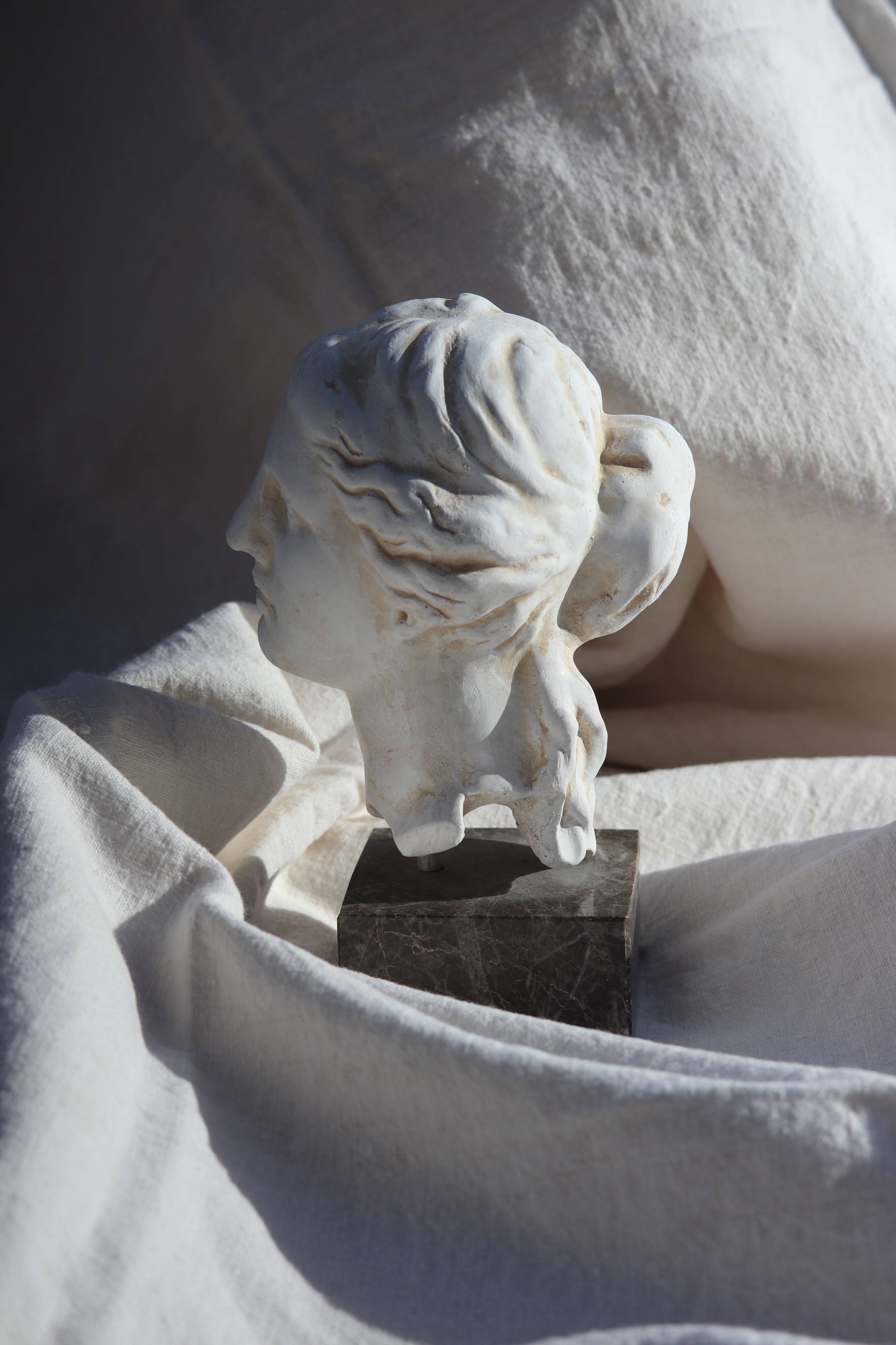 Plaster bust on a pedestal