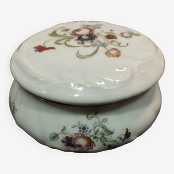 Old white porcelain candy box and floral decoration