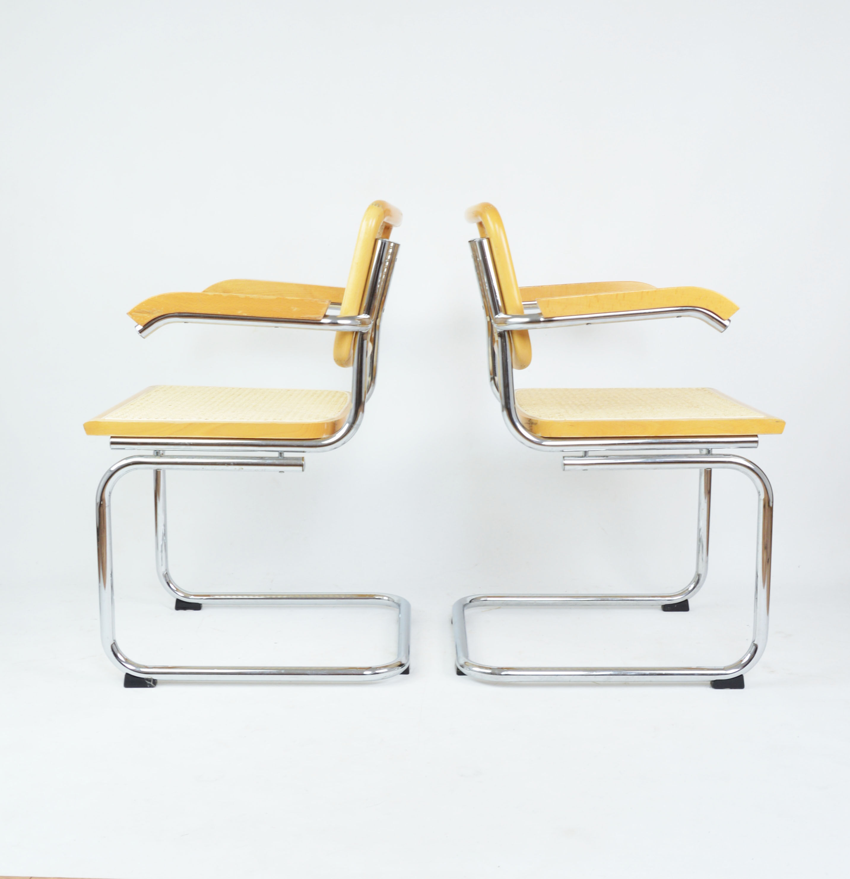 A pair of chairs with armrests, 1970s