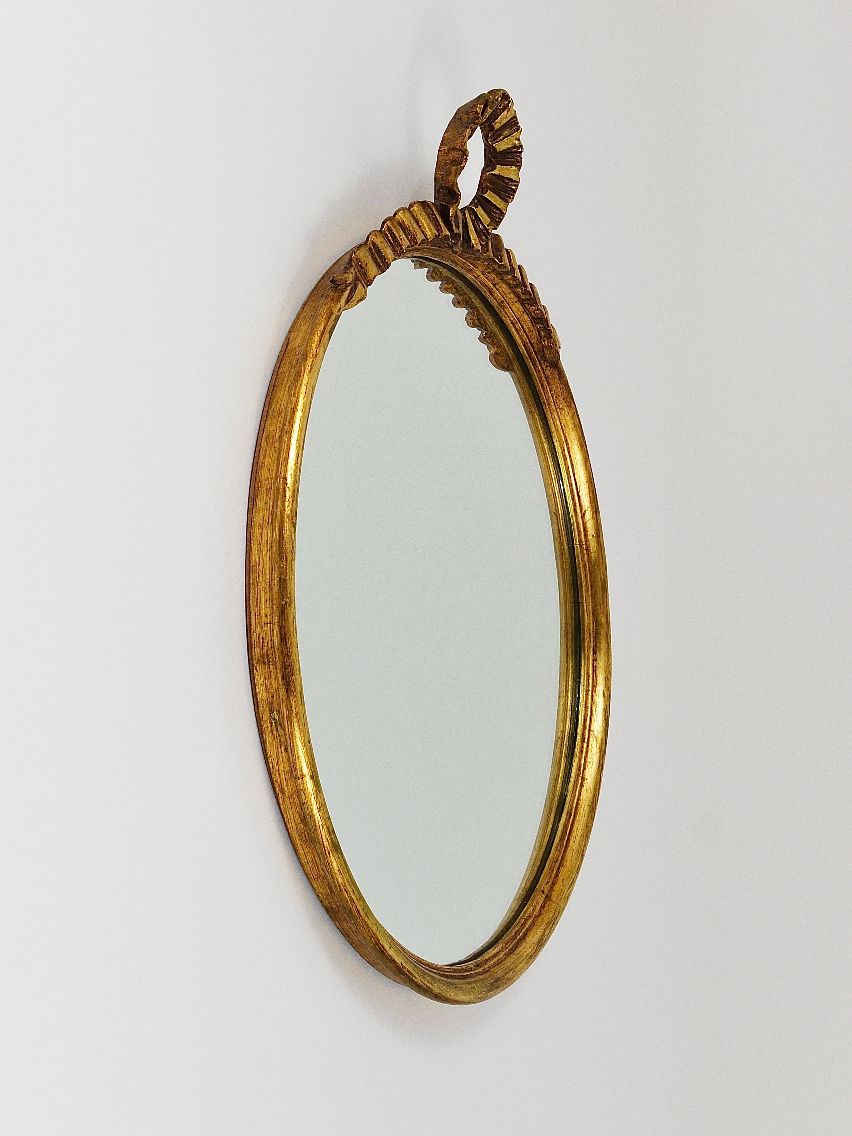 Round wall mirror in gilded wood, mid-century, C. Allodi & G. Subelli, Italy, 1950s.