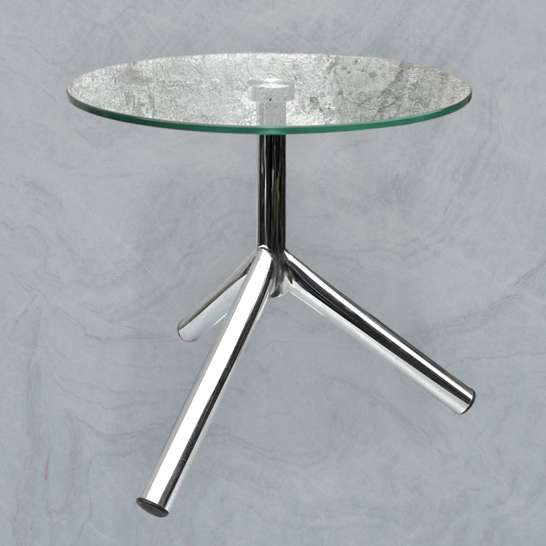 Modernist tripod side table in tempered glass and chrome metal.