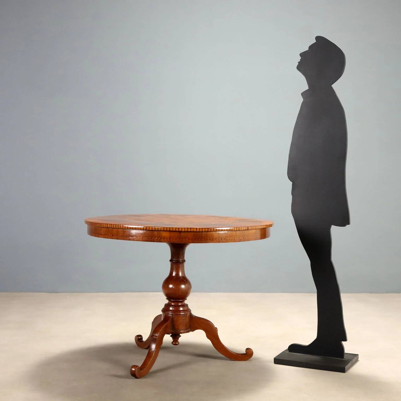Antique round walnut table with a baluster central leg, Italy, 19th century.