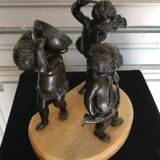 Three musician angels, bronze sculptures on a marble base.