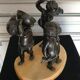 Three musician angels, bronze sculptures on a marble base.