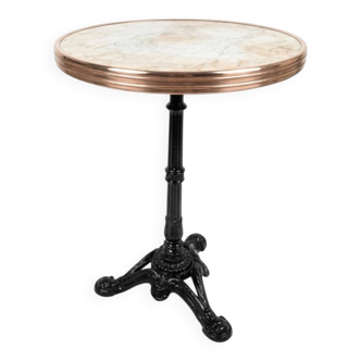 Bistro table with a marble top and brass, cast iron base.