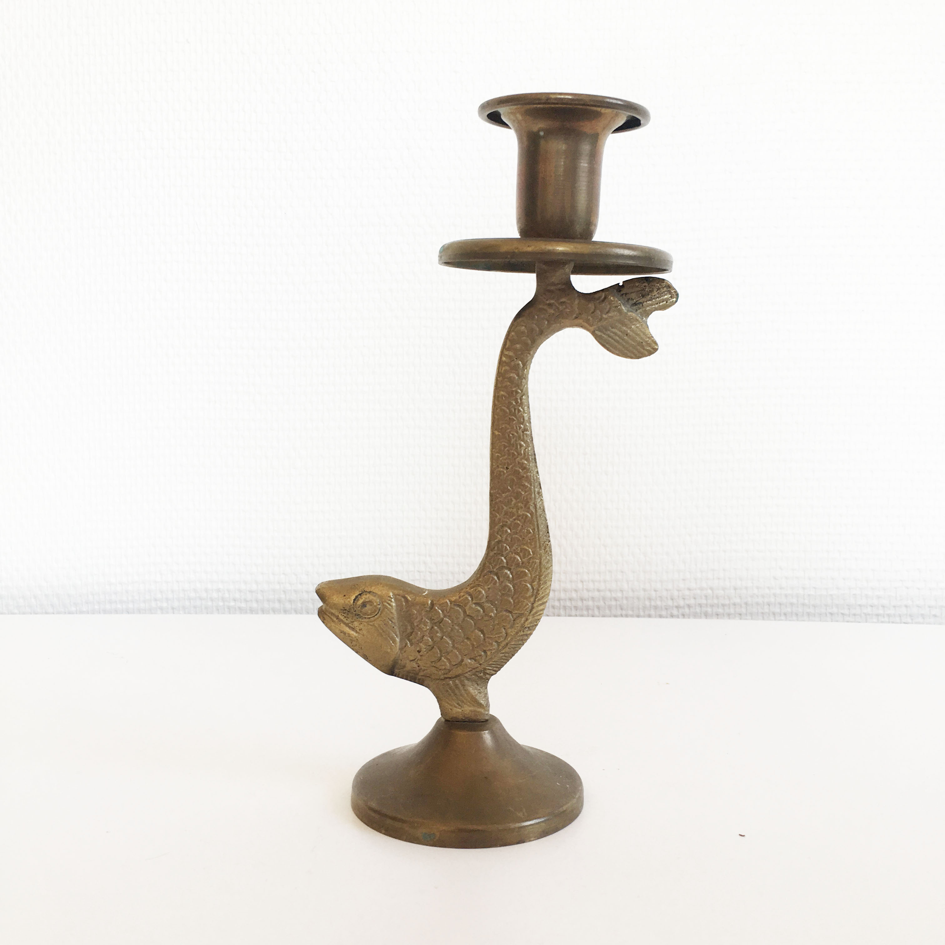 Old golden brass fish candlestick