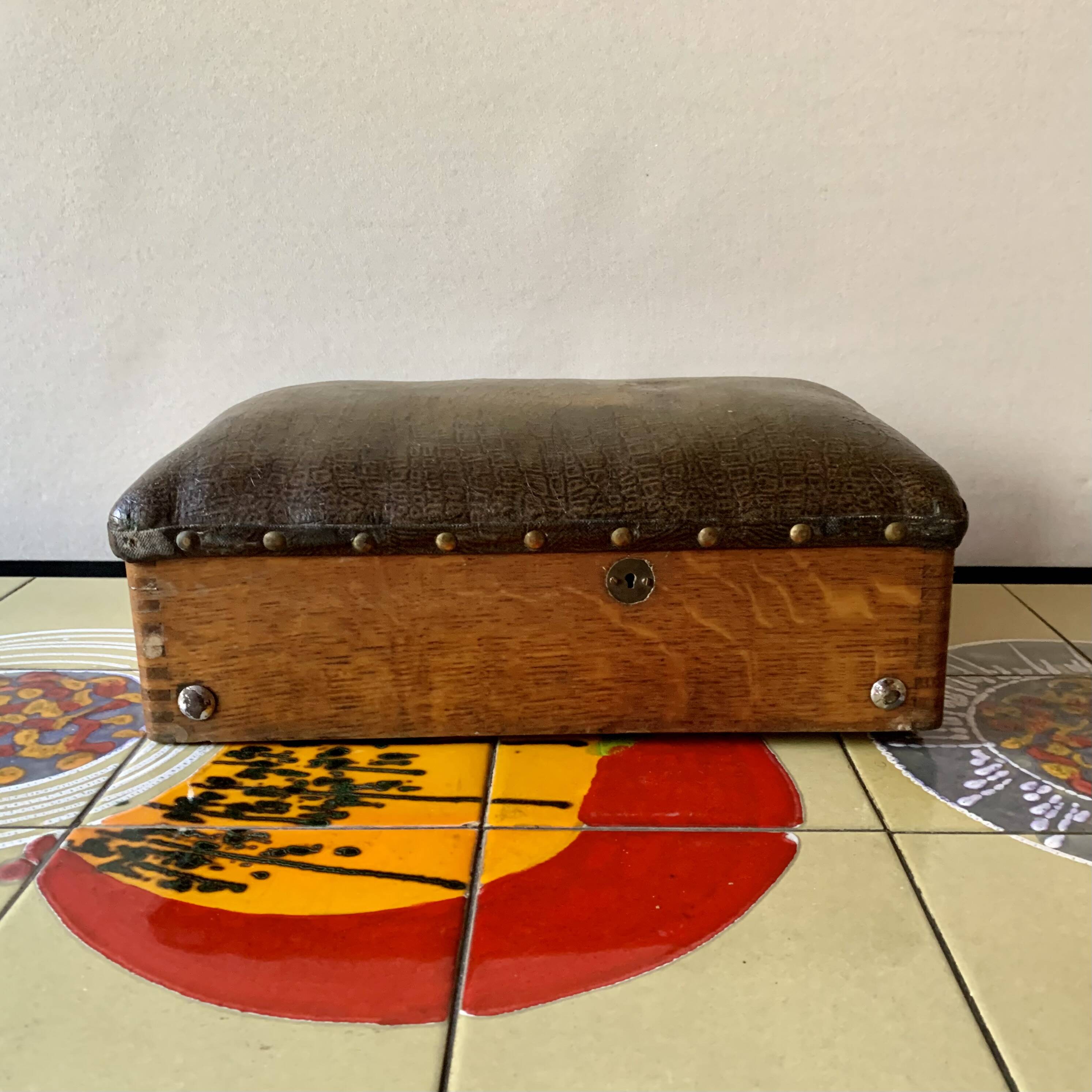 Old foldable fisherman's stool in wood and leather