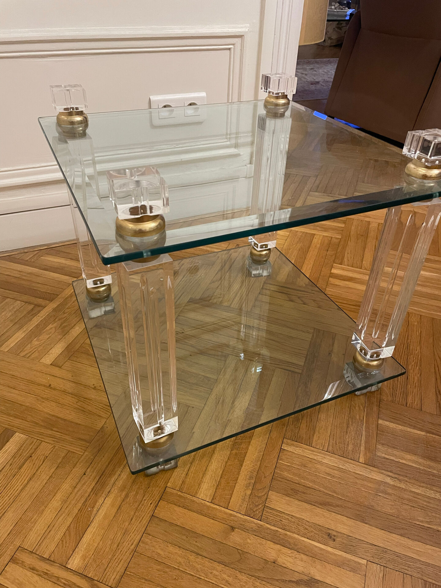 Glass side table with gold decorations.