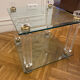 Glass side table with gold decorations.