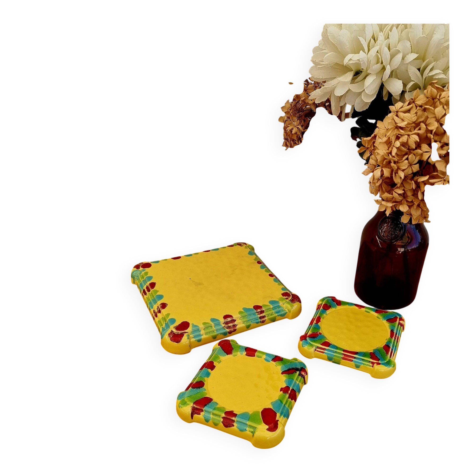 Yellow ceramic trivet and bottle coaster with vintage painted decoration.