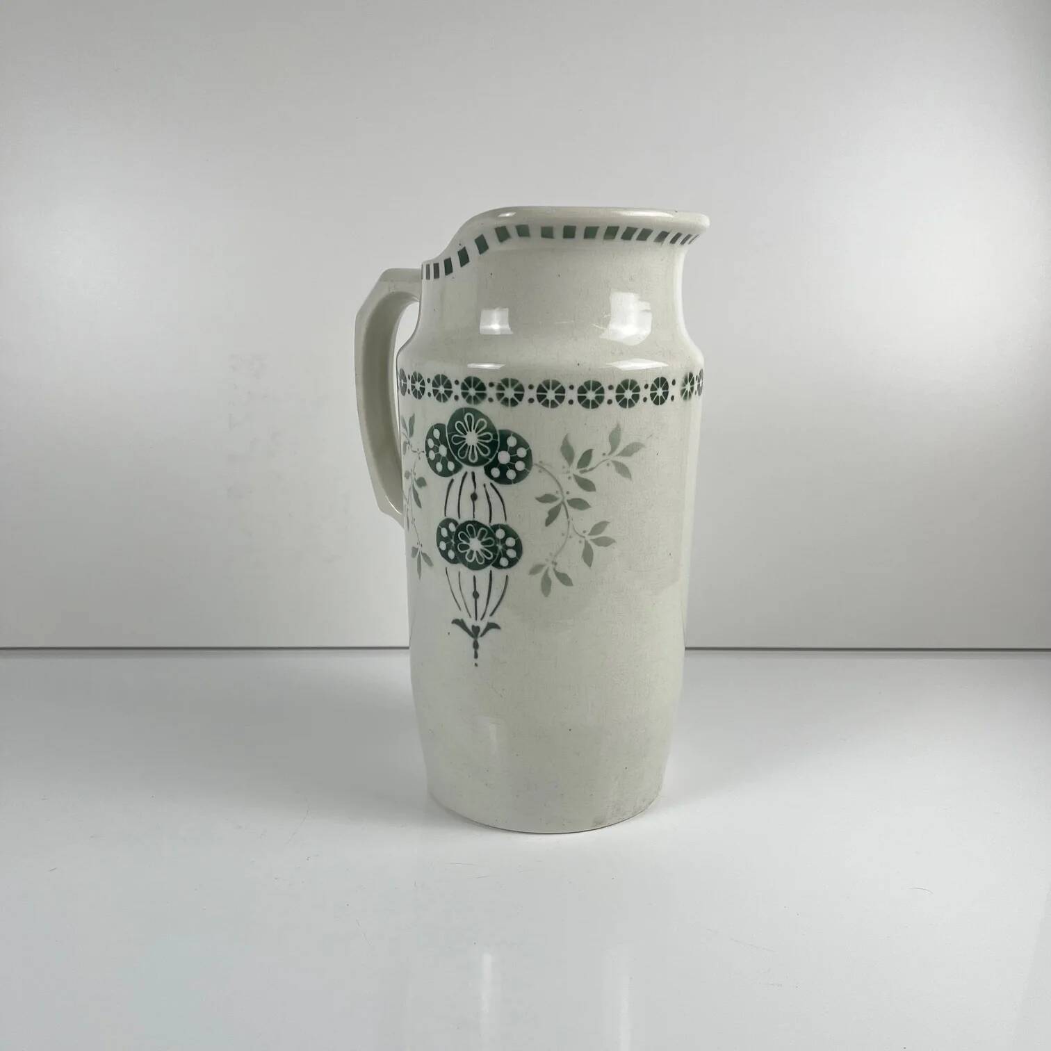 Antique earthenware pitcher, green floral decoration, fine ironstone from the late 19th to early 20th century.