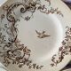 4 assiettes plates en terre de fer marron à décor d'oiseaux