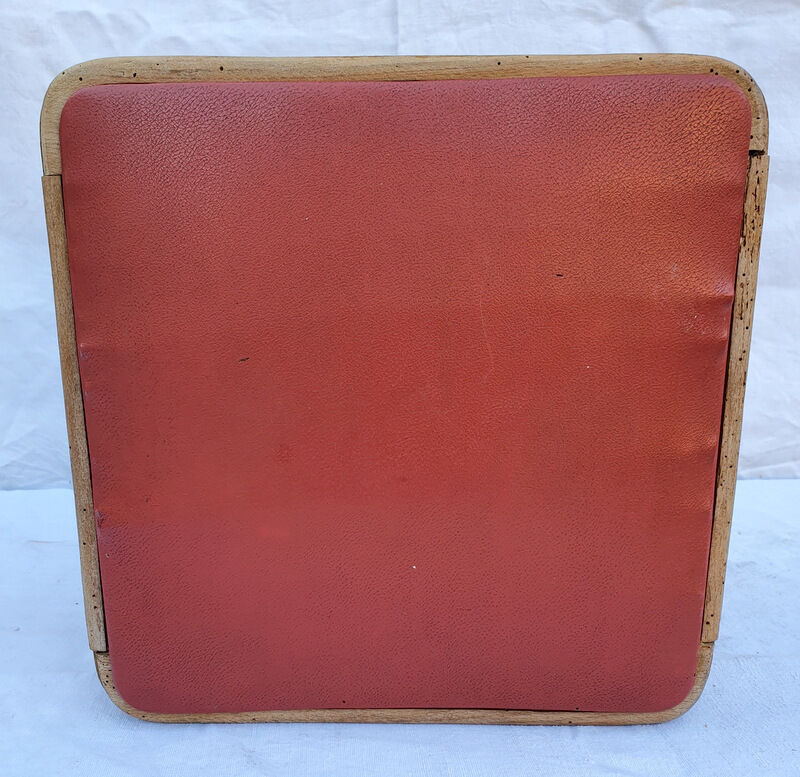 Vintage wooden stool and red skai seat
