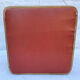 Vintage wooden stool and red skai seat