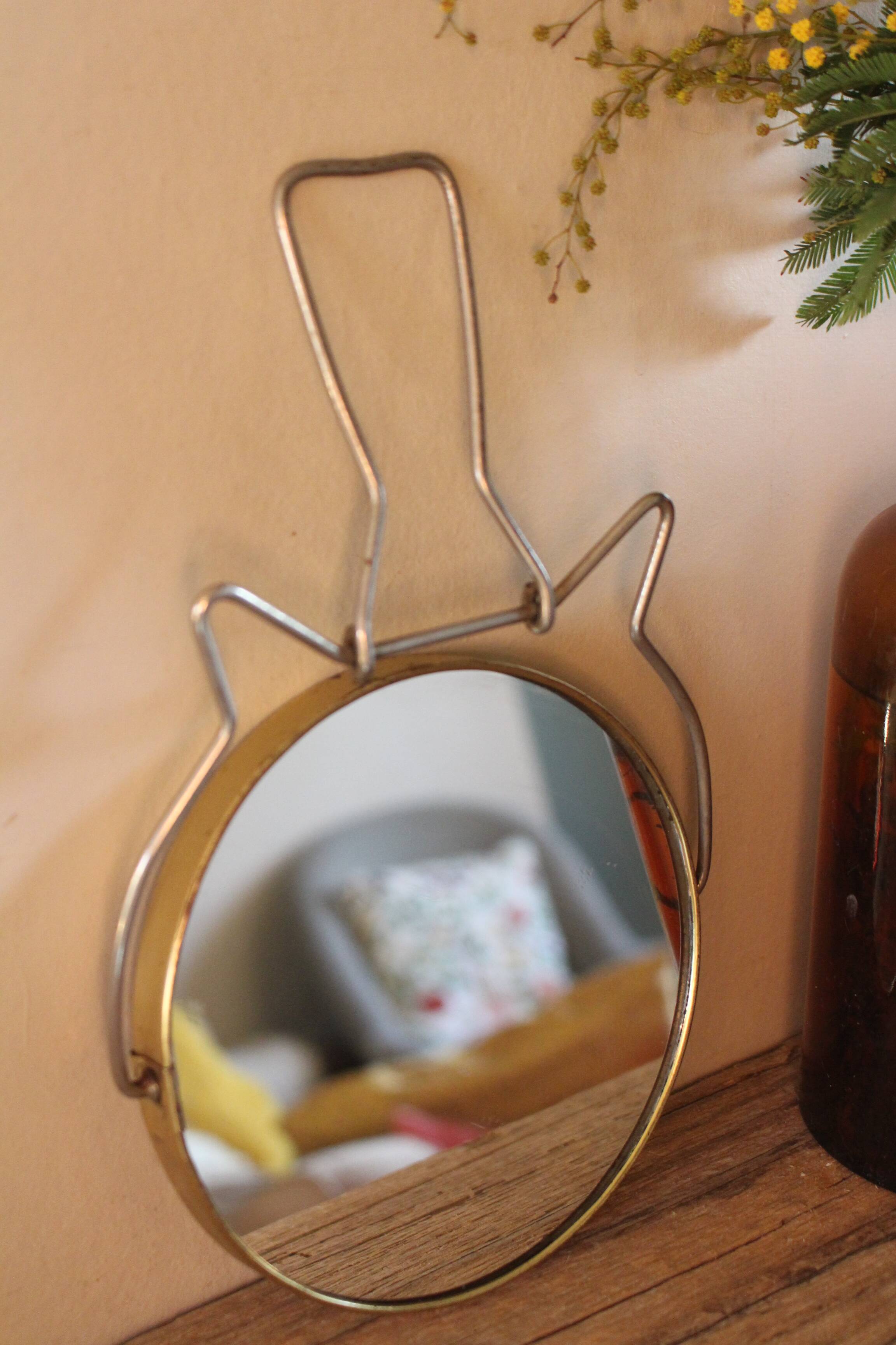 Antique round barber mirror in gilded metal