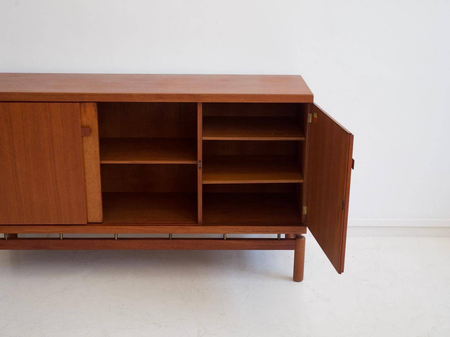 Modern mid-century teak sideboard with brass details.