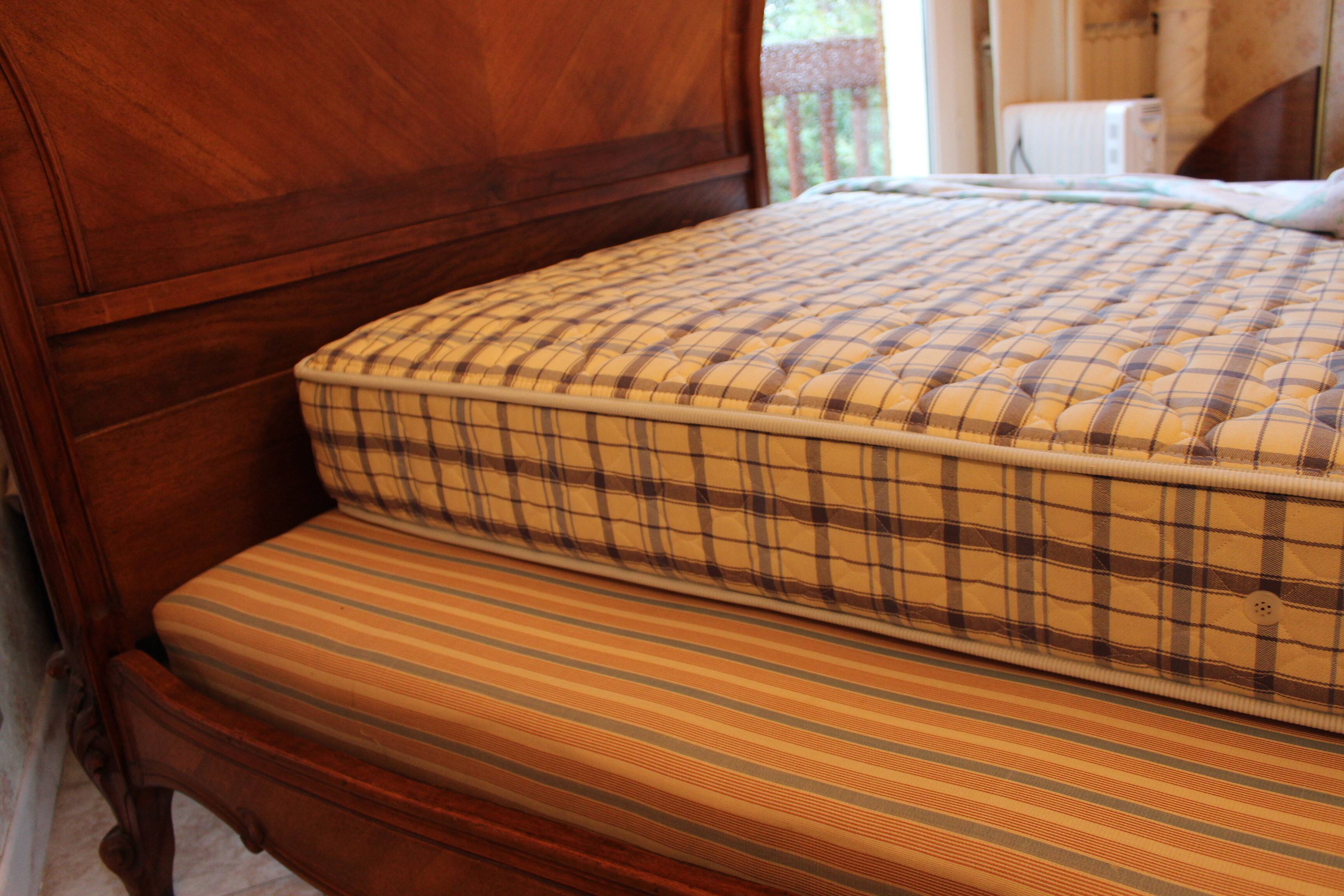 Walnut rocaille bed from the early 20th century.